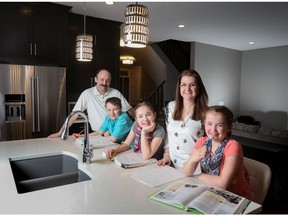 Derek and Nicole Bigelow and their children Kaleb, 13 and the twins Chloe and Samantha, 10, in their new home by Broadview Homes in Ravenswood.