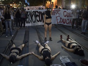Demonstrators perform during a protest against the murder of councilwoman Marielle Franco in Rio de Janeiro, Brazil, Tuesday, March 20, 2018. Franco's murder came just a month after the government put the military in charge of security in Rio, which is experiencing a sharp spike in violence less than two years after hosting the 2016 Summer Olympics. (AP Photo/Leo Correa) ORG XMIT: XLC110
