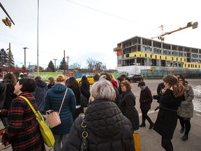 Guests walk toward the under construction YWCA building in Inglewood on Monday March 26, 2018. Lori Sigurdson, Minister of Seniors and Housing announced $8.6 Million in funding for the project during the event. Gavin Young/Postmedia