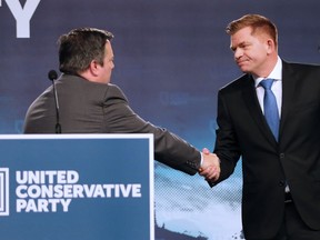 Jason Kenney, left, shakes hands with Brian Jean after Kenney was elected leader of the United Conservative Party in Calgary on Oct. 28, 2017.