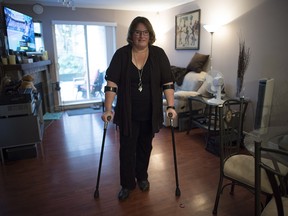 When Jeanine McDonald heard a pop in her low back as she bent down to pick up a lid from a box, she had no idea she'd ruptured a disc and would wait three months for surgery. Then a second disc ruptured and left her in more debilitating chronic pain, the kind that millions of Canadians live with daily. Macdonald is shown in her apartment in Coquitlam, B.C., Wednesday, March, 14, 2018.