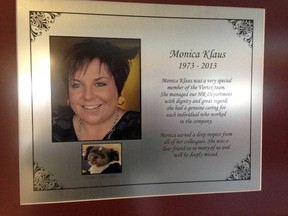 A plaque remembering the lives of Monica Klaus and the family dog Patches hangs on a wall at Vortex Production Services, in Settler, Alta.