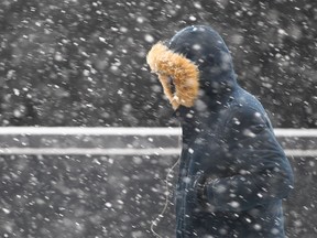 Calgarians brave the heavy snow as they walk along Centre St near 7 Ave SW in downtown Calgary on Thursday, March 15, 2018. More winter weather is set to hit southern Alberta, just as residents had dreams of spring. Jim Wells/Postmedia