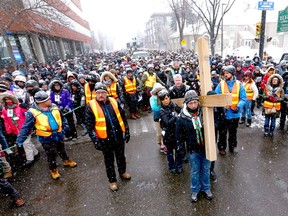 The Way of the Cross proceeds down 2 St SW with hundreds of supporters in downtown Calgary on Friday, March 30, 2018. Jim Wells/Postmedia