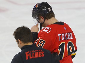 Calgary Flames Matthew Tkachuk is helped off the ice after falling heavily into the boards during a game against the New York Islanders on March 11, 2018.