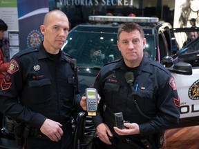 Staff Sgt. Cory Dayley, left, and Sgt. Andy MacLeod of the Calgary police cybercrimes unit. They say scammers demanding payment via cryptocurrencies like bitcoin have largely replaced gift cards and wire transfers. Bryan Passifiume/Postmedia Network