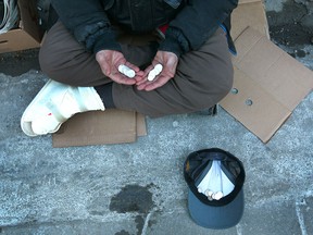 Steven Cracknell, orignially from Guelph, ON shows the profits of panhandling in downtown Calgary on Wednesday, February 28, 2018. Cracknell says he panhandles and bottle picks during the day to survive and to buy his next bottle or whiskey, vodka or beers. Cracknell says he gets drunk every day so he doesnt have to feel or think about anything. His foot was injured after a car jumped the curb and ran over his feet. A few days later he was hit by a car and broke his ankle. Jim Wells/Postmedia