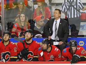 Calgary Flames bench watches the clock wind down during a demoralizing loss against the New York Islanders at the Saddledome on March 11, 2018.