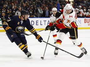 Buffalo Sabres Casey Nelson (8) defends Calgary Flames forward Mark Jankowski (77) during the first period of an NHL hockey game, Wednesday, March. 7, 2018, in Buffalo, N.Y. (AP Photo/Jeffrey T. Barnes) ORG XMIT: NYJB102