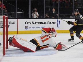 William Karlsson #71 of the Vegas Golden Knights scores the first of his three goals in the second period against Mike Smith #41 of the Calgary Flames during their game at T-Mobile Arena on March 18, 2018 in Las Vegas, Nevada.