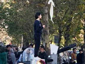 The protests are inspired by the actions of a 31-year-old woman, now dubbed the "Girl of Enghelab Street" who was arrested in December when she took off her headscarf and held it in the air while standing on a pillar box in Central Tehran.