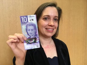 Michelle Marselle, senior analyst in the currency department of the Bank of Canada with the new $10 bill which will go into circulation by the end of 2018.