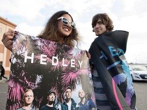 Hedley fan's Charene Gonschorek, left, and Brandon Krys show their support for the band before the final concert of their current tour in Kelowna, B.C., on Friday, March 23, 2018. The band's tour has been overshadowed by allegations of sexual misconduct. The band was dropped from their management company, The Feldman Agency, their songs were pulled from radio stations across the country and a planned performance at the Juno Awards was cancelled. Following the tour, Hedley has announced that they will be taking an indefinite hiatus from music.