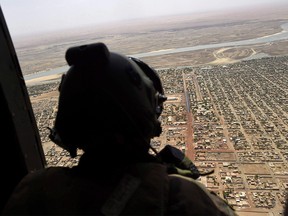 Canada's contribution to the UN peacekeeping mission in Mali is expected to include up to six helicopters and a sizeable female presence, all of which will be operating in an area rife with Islamic terrorists, Tuareg rebels - and an unforgiving climate. A French soldier stands inside a military helicopter during a visit by French President Emmanuel Macron to the troops of Operation Barkhane, France's largest overseas military operation, in Gao, northern Mali, Friday, May 19, 2017. THE CANADIAN PRESS/AP-Christophe Petit Tesson, POOL ORG XMIT: CPT110