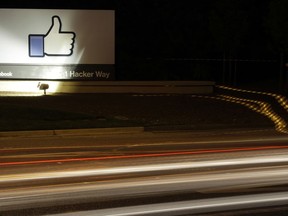 FILE - In this June 7, 2013, file photo, the Facebook "like" symbol is on display on a sign outside the company's headquarters in Menlo Park, Calif. On a day when our virtual friends wrung their virtual hands about whether to leave Facebook, a thoroughly 21st-century conundrum was hammered home: When your community is a big business, and when a company's business is your community, things can get messy.