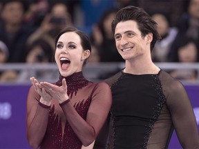 ONE OF 13 IMAGES OF PHOTO PACKAGE LOOKING BACK AT VIRTUE AND MOIR'S COMPETITIVE CAREER Ice dance gold medalists Canada's Tessa Virtue blows a kiss as Scott Moir looks on during victory ceremonies at the Pyeongchang Winter Olympics Tuesday, February 20, 2018 in Gangneung, South Korea. THE CANADIAN PRESS/Paul Chiasson ORG XMIT: CPT713