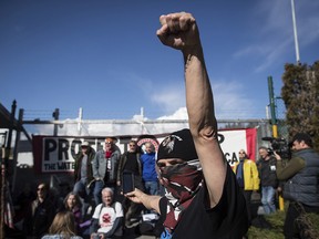 About 30 protesters block a gate outside the Kinder Morgan facility in Burnaby, B.C. on March 17, 2018.