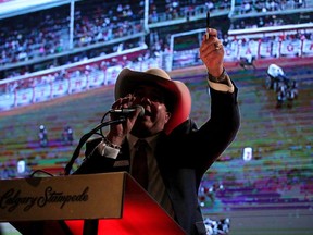 Auctioneer Rob Bergevin takes bids at the annual Calgary Stampede chuckwagon tarp auction in Calgary, Alta., on Thursday March 19, 2015. Mike Drew/Calgary Sun/QMI Agency