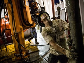 Russell Girsh, a floor hand for Raven Drilling, lines up a pipe while drilling for oil in the Bakken shale formation on July 23, 2013, outside Watford City, N.D.