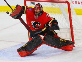 Calgary Flames goaltender Mike Smith makes an unconventional save against the Oilers at the Scotiabank Saddledome on Tuesday, March 13, 2018.
