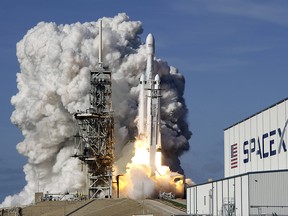 A Falcon 9 SpaceX heavy rocket lifts off from pad 39A at the Kennedy Space Center in Cape Canaveral, Fla., Tuesday, Feb. 6, 2018.