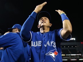 In this Sept. 30, 2015 file photo, Munenori Kawasaki celebrates the Toronto Blue Jays' AL East-clinching victory in Baltimore.