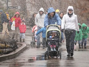 Families stroll through the falling snow at the Easter Eggstravaganza at the Calgary Zoo in Calgary, Alta., on Friday April 18, 2014. Mike Drew/Calgary Sun/QMI Agency
