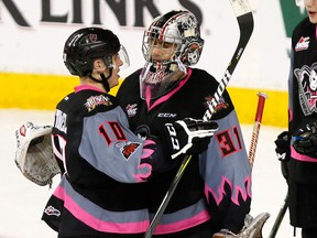 Calgary Hitmen L-R, Jakob Stukel and Nick Schneider wish each other well after losing their last game as Hitmen to the Edmonton Oil Kings at the Scotiabank Saddledome in Calgary on Sunday, March 18, 2018.