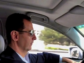 This frame grab from video released Sunday, March, 18, 2018 by the official Facebook page of the Syrian Presidency, shows Syrian President Bashar Assad driving himself to the newly captured areas of eastern Ghouta, near the capital Damascus, Syria.