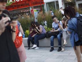 Gamers use their phones during the Pokemon Go release party in Toronto on July 18, 2016. When looking at how Canadians used the internet throughout 2017, growth in time spent with the Top 100 most popular online properties excluding Facebook and Google sites was consistently strong.