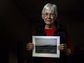 Glenna Gardiner holds a photograph of a Tom Thomson painting in her home. The Edmonton grandmother recently learned that a family heirloom that had been sitting in her basement was a painting by Thomson, which has been priced at up to $175,000.