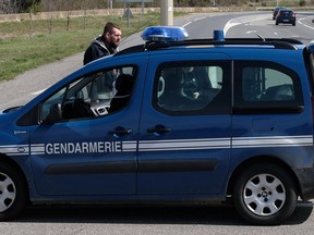 French gendarmes block access to Trebes, where a man took hostages at a supermarket on March 23, 2018, killing one and injuring a second.