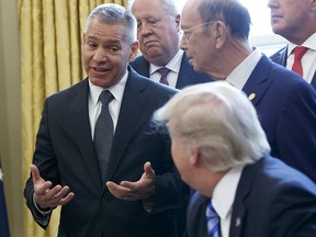 TransCanada CEO Russ Girling speaks to President Donald Trump in the Oval Office of the White House on March 24, 2017, during an announcement on the approval of a permit to build the Keystone XL pipeline.