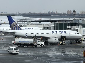 In this March 15, 2017, file photo, United Airlines jets sit on the tarmac at LaGuardia Airport in New York. A dog died on a United Airlines plane after a flight attendant ordered its owner to put the animal in the plane's overhead bin.