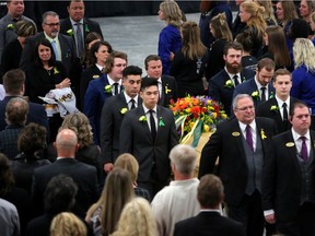 Pallbearers carry Logan Boulet's casket out of Nicholas Sheran Ice centre in Lethbridge, Ab., on Saturday April 14, 2018 for Logan Boulet's funeral. Leah Hennel/Postmedia