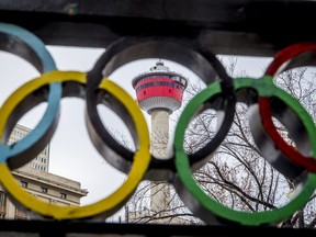 The Calgary Tower is seen with Olympic rings built into railing at Olympic Plaza in downtown Calgary.