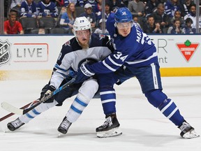 Winnipeg Jets forward Patrik Laine (left) battles Toronto Maple Leafs forward Auston Matthews on March 31.