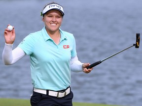 Brooke Henderson of Canada celebrates her final putt and a four-shot victory on the 18th green to win the LPGA Lotte Championship at the Ko Olina Golf Club in Kapolei, Hawaii, on Saturday.
