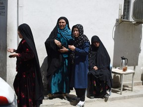 Afghan residents weep for their relatives following a suicide bombing attack at the Isteqlal Hospital in Kabul on April 22, 2018.