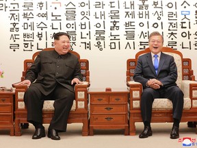 This picture taken on April 27, 2018 and released from North Korea's official Korean Central News Agency (KCNA) on April 29, 2018 shows North Korea's leader Kim Jong Un (L) talking with South Korea's President Moon Jae-in (R) before the inter-Korean summit at the Peace House building on the southern side of the truce village of Panmunjom.