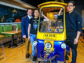 John Roberts, VP Operations; Sam Chanhao, owner; and chef Chalermphon (Pon) Limsrijamrern pose at Tuk Tuk Thai restaurant in Signal Hill Centre. Al Charest/Postmedia