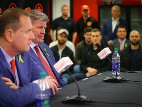 Calgary Flames GM Brad Treliving and the teams new head coach Bill Peters during a press conference in the Ed Whalen Media Lounge at the Scotiabank Saddledome in Calgary.  Al Charest/Postmedia