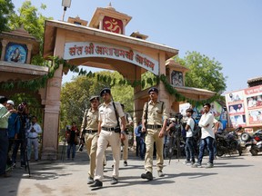 Indian policemen keep vigil outside an ashram of controversial spiritual guru Asaram Bapu in Ahmadabad, India, Wednesday, April 25, 2018. An Indian court has found the high-profile guru guilty of raping a teenage female devotee in 2013.