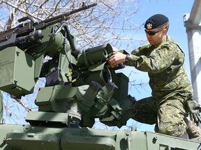 Sgt Jesse Anderson, from the King's Own Calgary Regiment works the remote weapons system on top of a newly delivered Tactical Armoured Patrol Vehicle which was on display in front of Mewata Armoury in downtown Calgary on Sunday, April 22, 2018. The Regiment was celebrating the St. George's Day Parade in the Armoury. Jim Wells/Postmedia