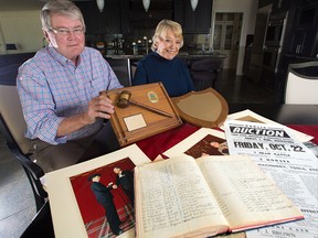 Doug and Diane Hunter with memorabilia from Diane's father, famed auctioneer Vern Scown. The couple are donating $1.5 million to the Calgary Stampede for the Vern Scown Western Heritage Gallery to be built on the Stampede grounds.