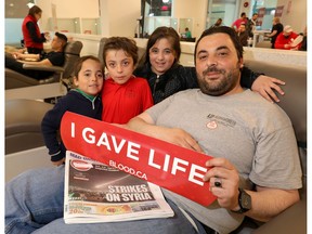 Dad, Ayman Noufl with his family L-R, Mohanad,6, Mazen,7, and Rawan,9, before giving blood during Syrian Canadian Donation Day at the Canadian Blood Services at Eau Claire Market in Calgary on Saturday April 14, 2018. Darren Makowichuk/Postmedia
