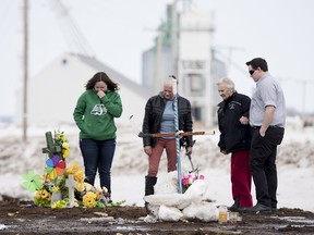 People visit the intersection of a fatal bus crash near Tisdale, Sask., Monday, April, 9, 2018. A bus carrying the Humboldt Broncos hockey team crashed into a truck en route to Nipawin for a game Friday night killing 15 and sending over a dozen more to the hospital.