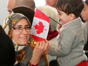 New Canadian citizen Masoumeh Mollaei shares a moment with her son Ali 2 1/2 after receiving her Canadian citizenship during a citizenship ceremony at the Westwinds Ismaili Jamatkhana on Wednesday April 11, 2018.