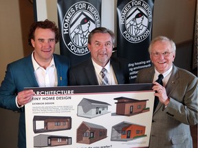 David Howard, left and Murray McCann, right, co-founders of Homes For Heroes stand with Mustard CEO Steve Wile as they display designs for tiny homes that will be built for veterans in a new community in Bridgeland. The Mustard Seed will provide support services through an onsite resource centre. The organization made the announcement on Wednesday April 18, 2018. Gavin Young/Postmedia