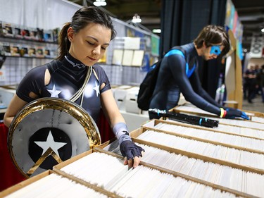 Chelsea Richardson dressed as comic hero Donna Troy and and Hunter Murray as Night Wing browse comics for sale at the Calgary Expo at Stampede Park on Sunday, April 29, 2018.